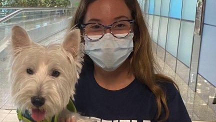 Jimena Guijarro, una de las dos estudiantes, abraza a su perro Tobi tras aterrizar en el aeropuerto de Madrid-Barajas.