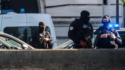 Varios policías franceses custodian la entrada en la Corte de París del convoy que transporta al acusado Abdeslam. (EFE)