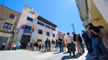 Los vecinos de Zuera esperan a las puertas del Ayuntamiento, donde está instalada la capilla ardiente de Luis Zubieta.