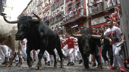 Mozos perseguidos por los toros de Victoriano del Río en el tercer encierro de los Sanfermines este martes, en Pamplona. / EFE