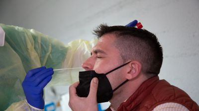 Un sanitario realiza una PCR a un hombre.