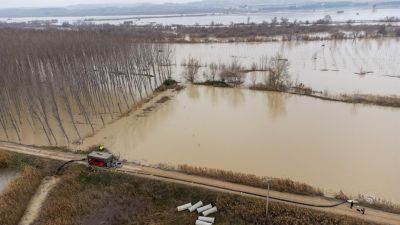 Miembros de la UME trasvasan agua de un colector al río en la localidad zaragozana de Pina de Ebro por la punta de la crecida del río que ha llegado con un caudal de 2.000 metros cúbicos, este miércoles. (EFE/Javier Cebollada).