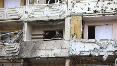 Un hombre limpia los escombros de un edificio dañado por los bombardeos en Kiev. / Foto: Miguel A. Lopes - EFE