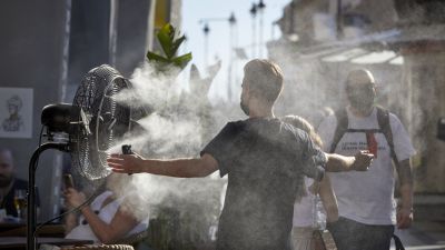 Un chico se refresca del calor con un difusor de vapor de agua. / Europa Press