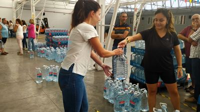 Una vecina recibe una de las garrafas que reparte el Ayuntamiento de Tarazona.