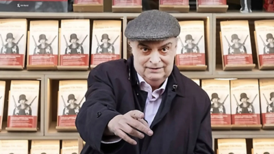 Enrique Vila-Matas posando frente a la puerta de una librería